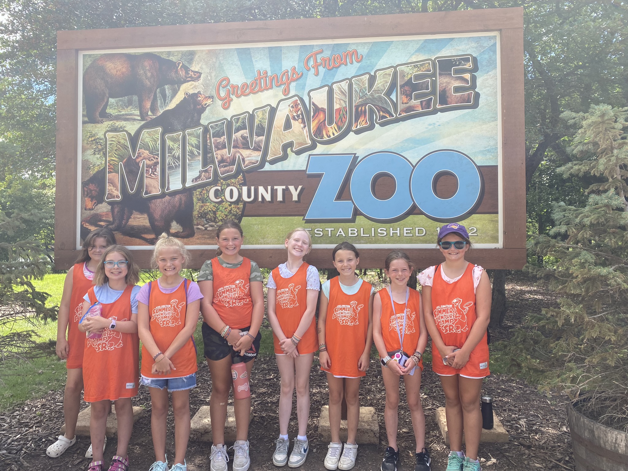 A picture of Summer Adventure Camp Senior campers in front of the Milwaukee County Zoo sign.